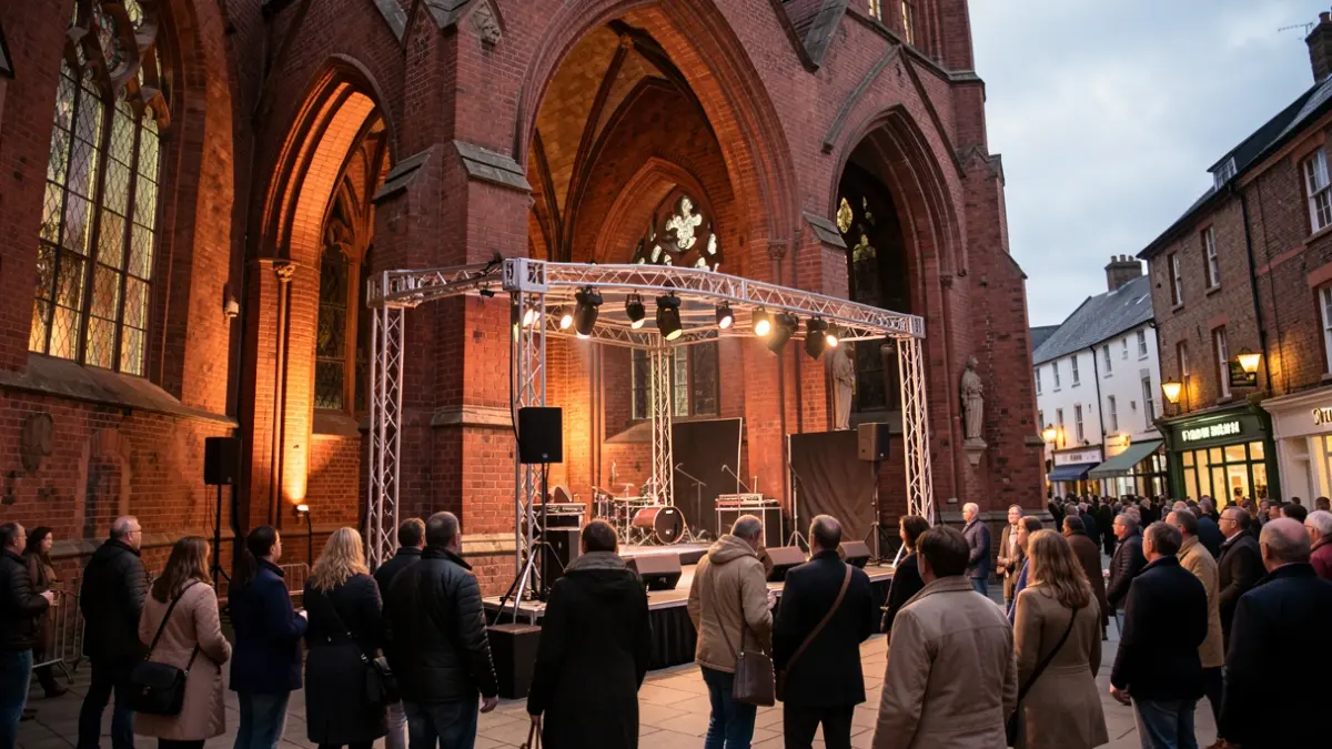 Generic image of a historic church interior with a stage and lighting, set up for a music performance.
